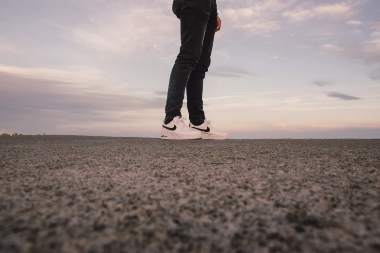 a person standing on top of a sandy beach