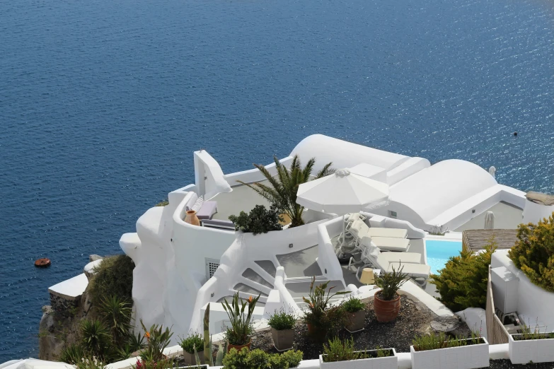 a man sitting on the top of a building next to water