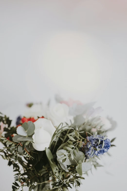 a vase filled with red white and blue flowers