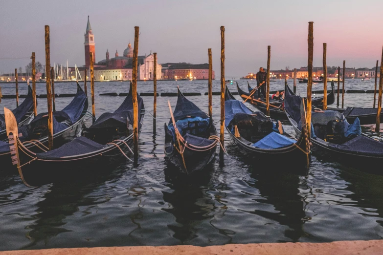 there are several gondolas parked in the water