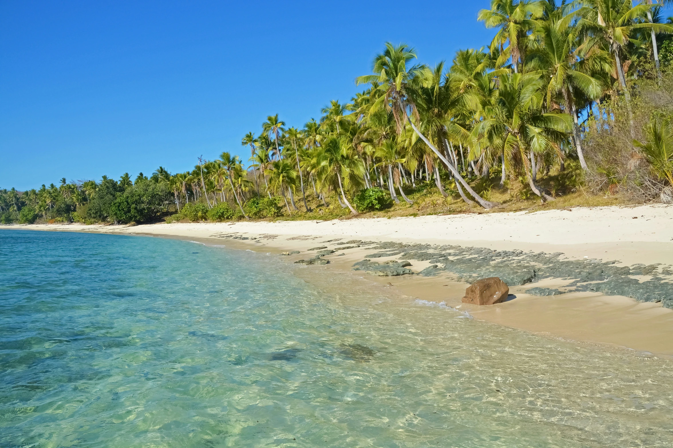 an empty beach is seen near the ocean