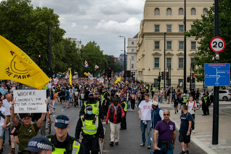 a crowd of protesters marching on a city street