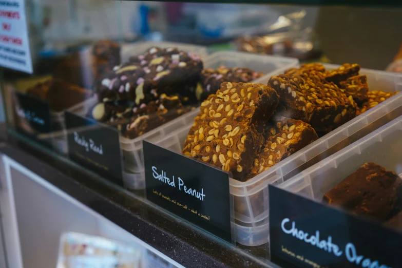 this is a display in a bakery showing chocolate covered doughnuts