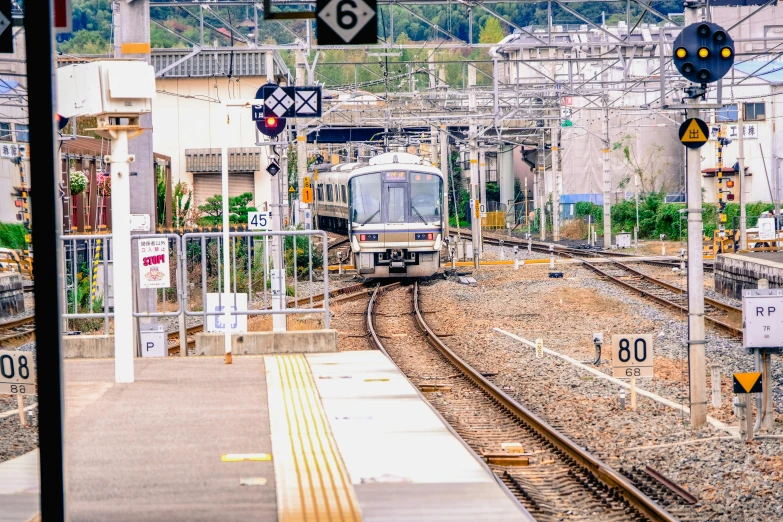 a train is traveling through a city by some train tracks