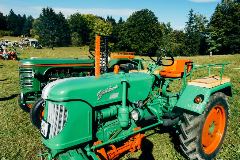 an old tractor sits on the grass