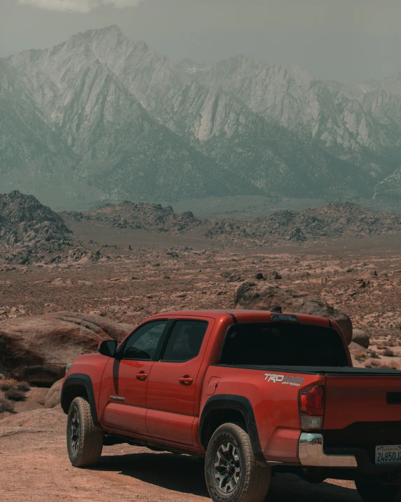 the pick up truck is parked in the desert