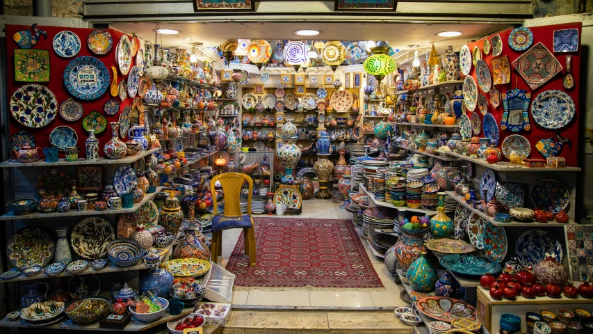 a collection of brightly colored ceramic bowls sitting on a display shelf