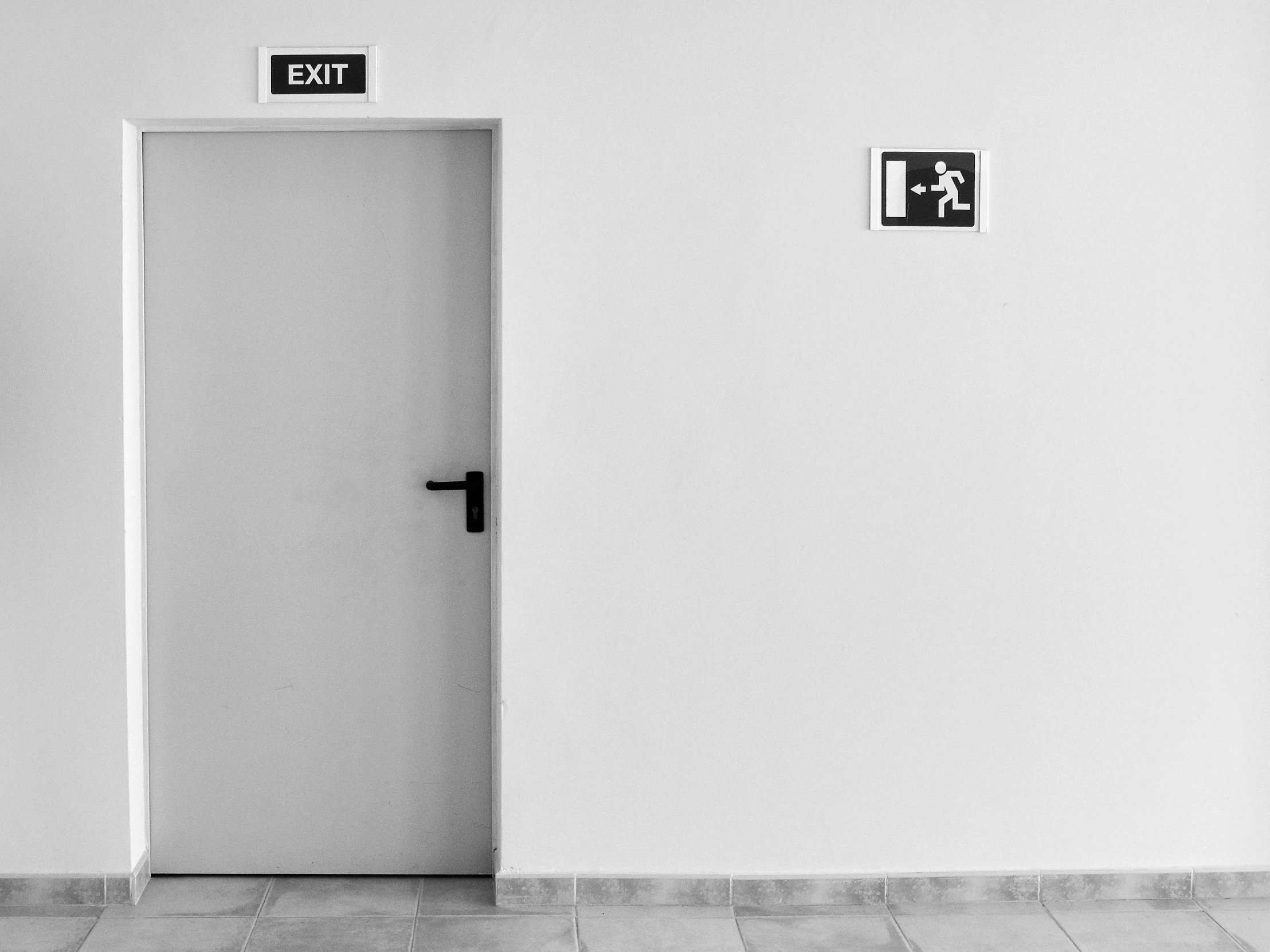 a restroom with a toilet in it and no one at the door