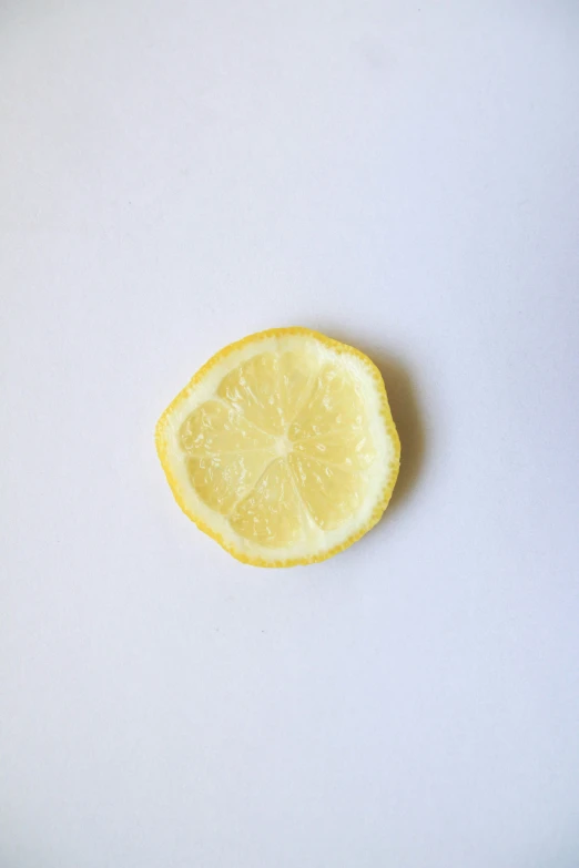 a lemon is sitting on a white surface