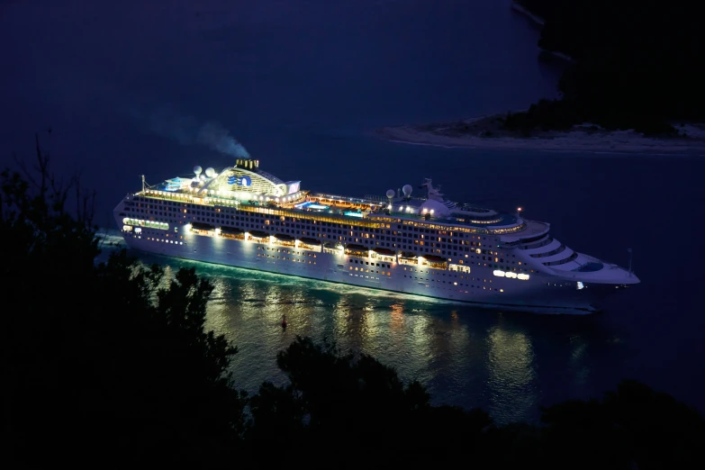 the large cruise ship is glowing at night