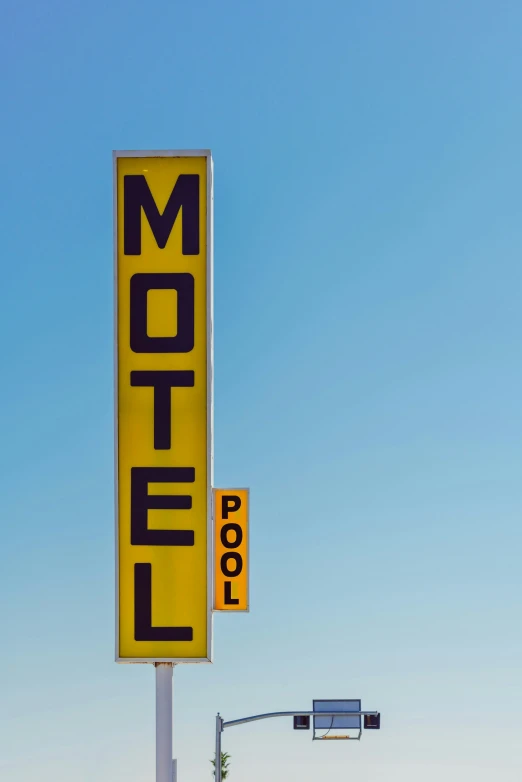 a motel sign next to a light with the word motel on it