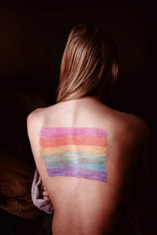 a person with colorful makeup on their back