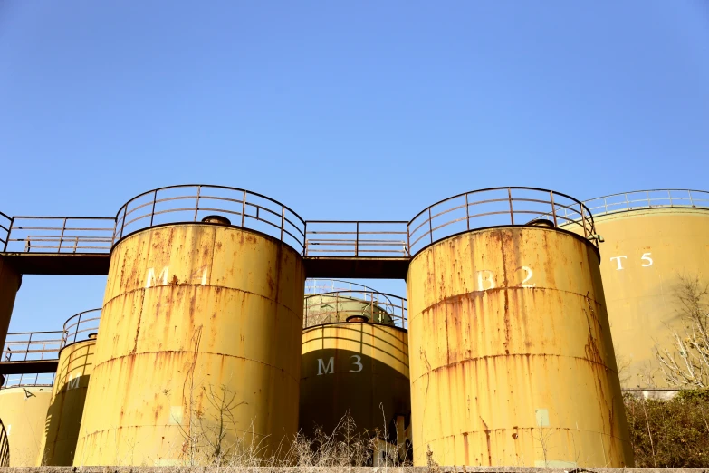 industrial pipes and tank sections are seen in this image