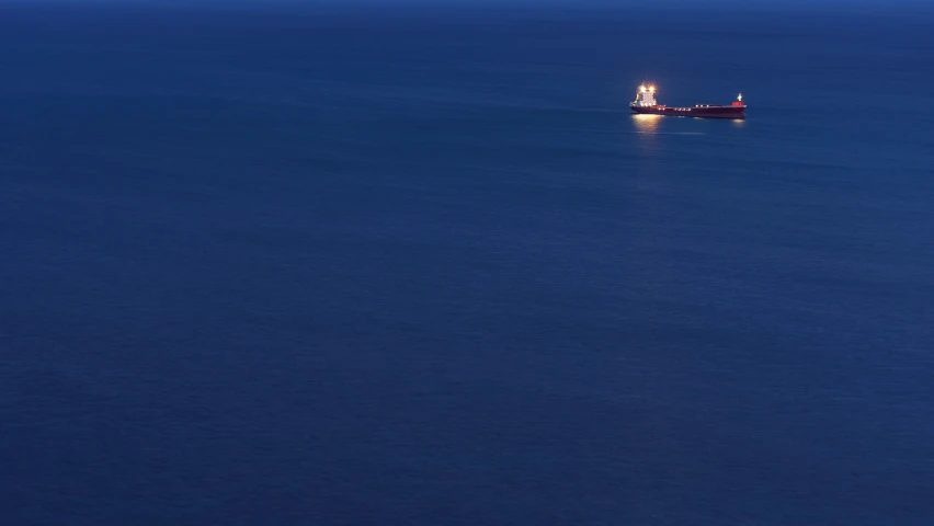 boat on the blue water at night with light