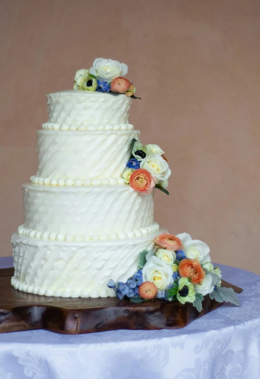 a tall white wedding cake on a table