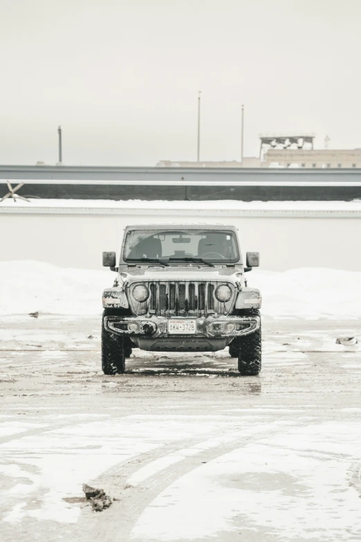 a black and white po of a jeep parked in the snow