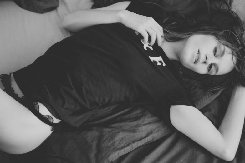 black and white po of woman laying on the bed