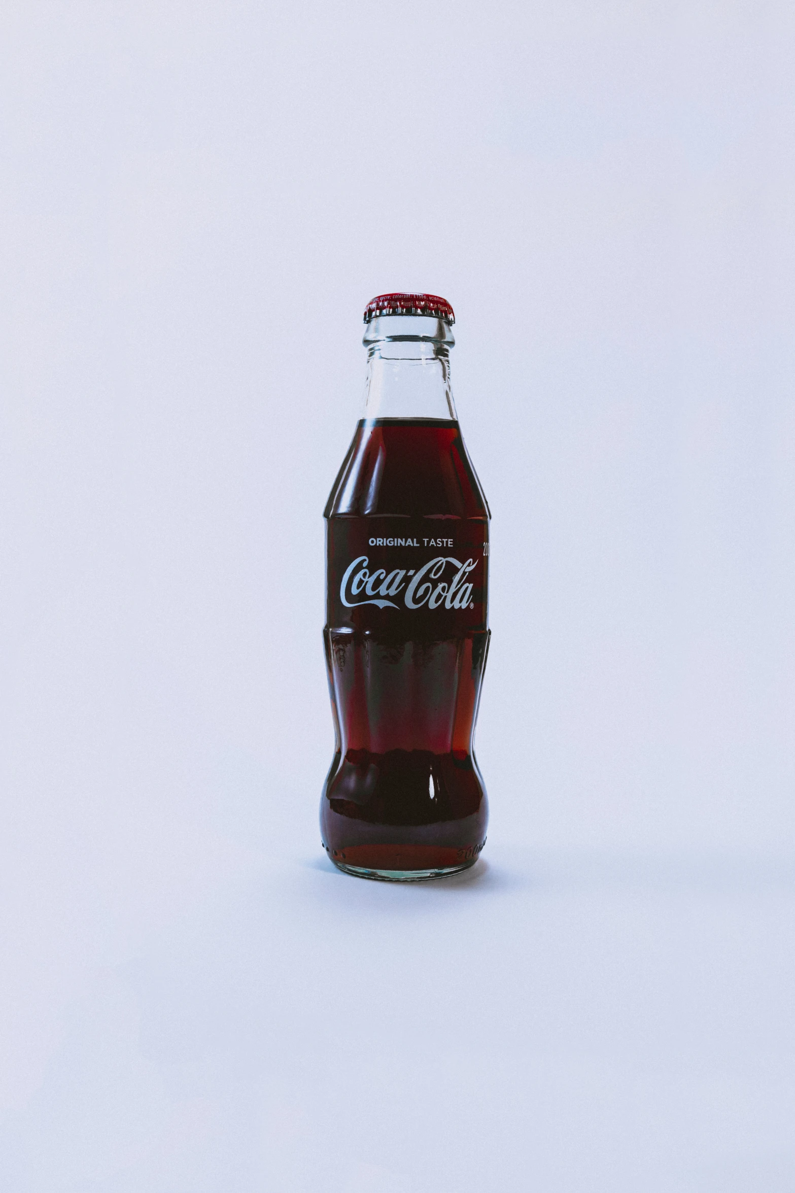 a bottle of soda on a plain white background