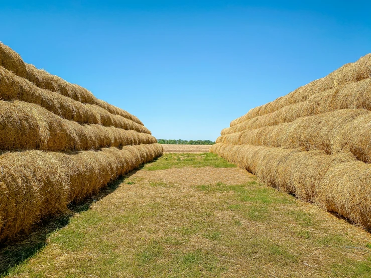 several large bales are stacked next to each other on a field