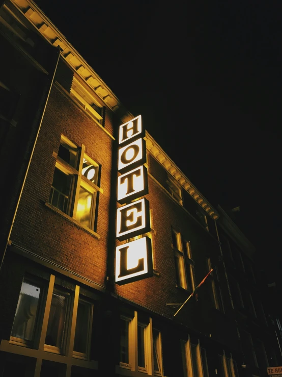 a el at night with a lit up sign on the building