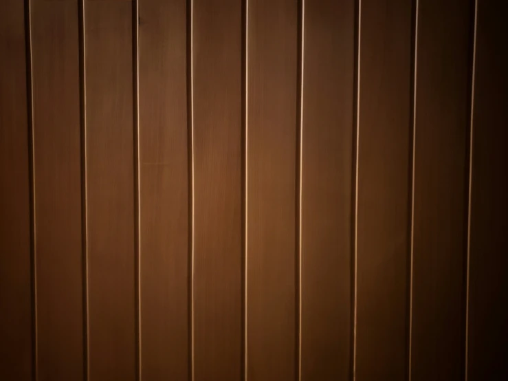 a wall with brown wood boards painted all the way down