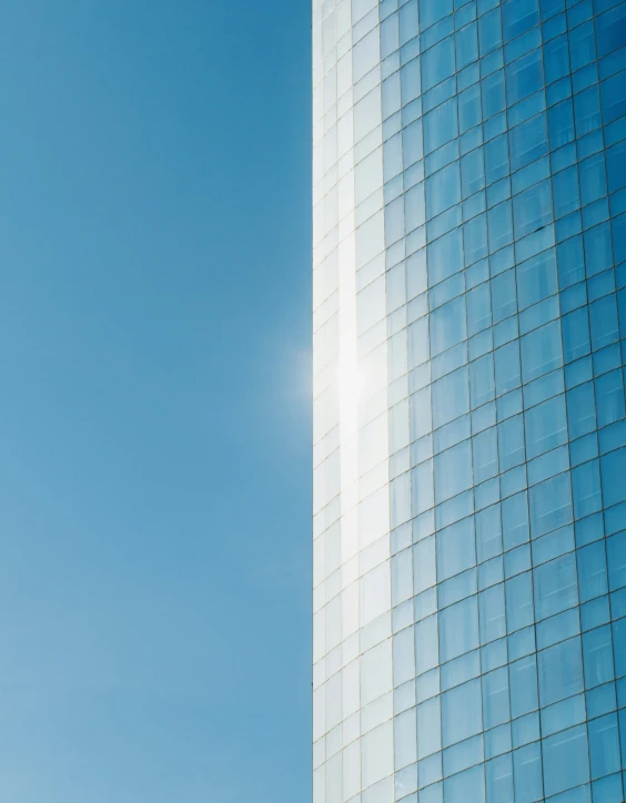 a tall building sitting next to a blue sky