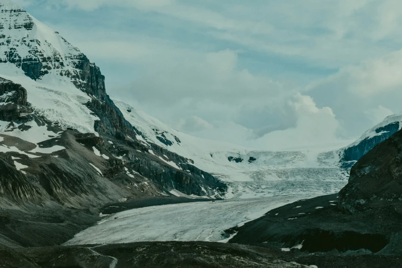 a snow covered mountain in a large valley