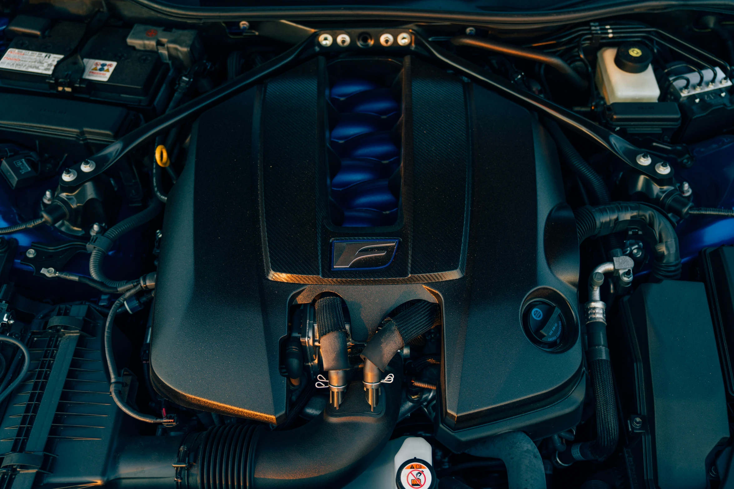 the engine of a blue car with a sticker of a person standing next to it