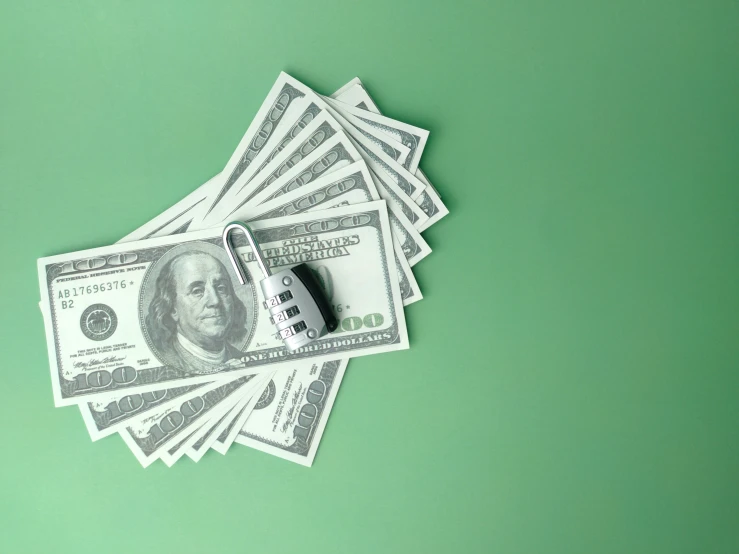 money and calculator on green background