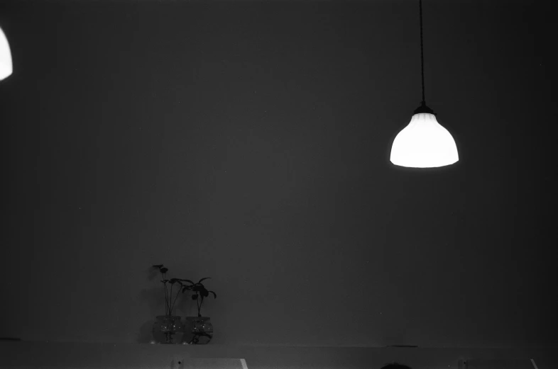 black and white image of a man sitting on his bed