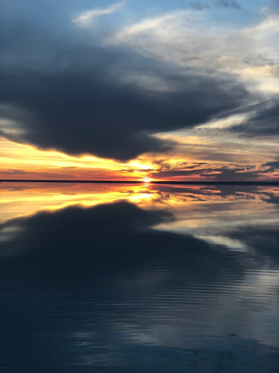 the sun is reflecting off the surface of the ocean