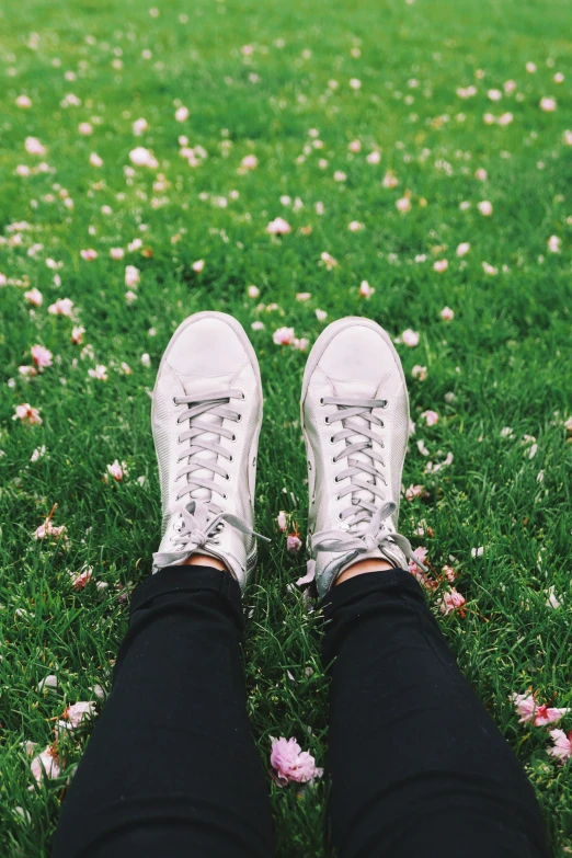 feet and shoe of a person standing in grass