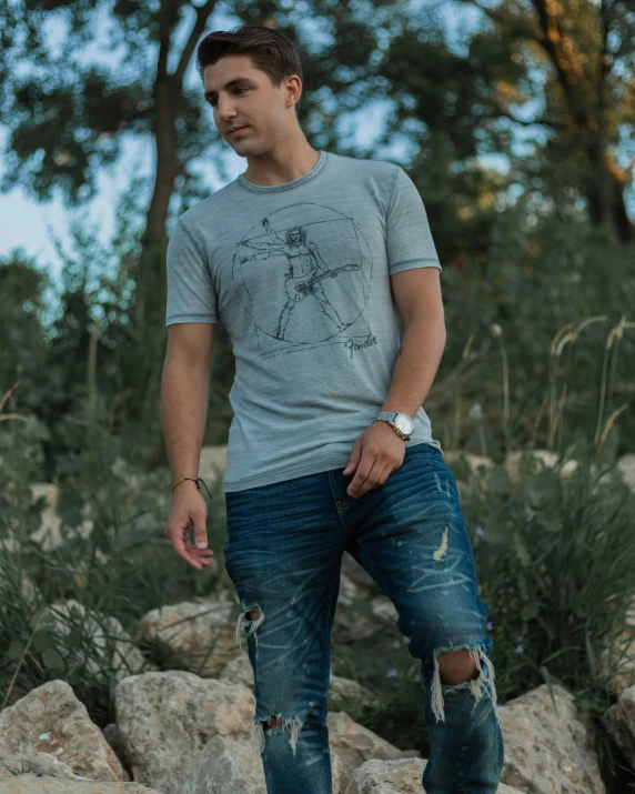 a man standing on rocks near tall grass