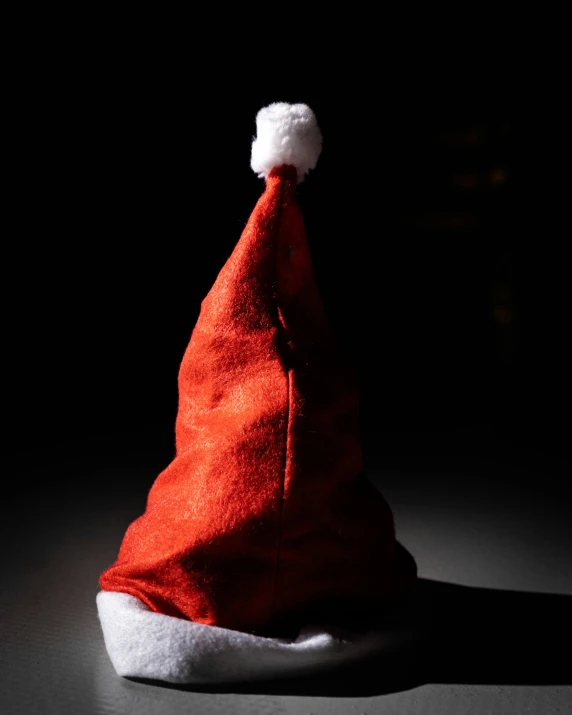 red santa hat sitting on top of a white bowl