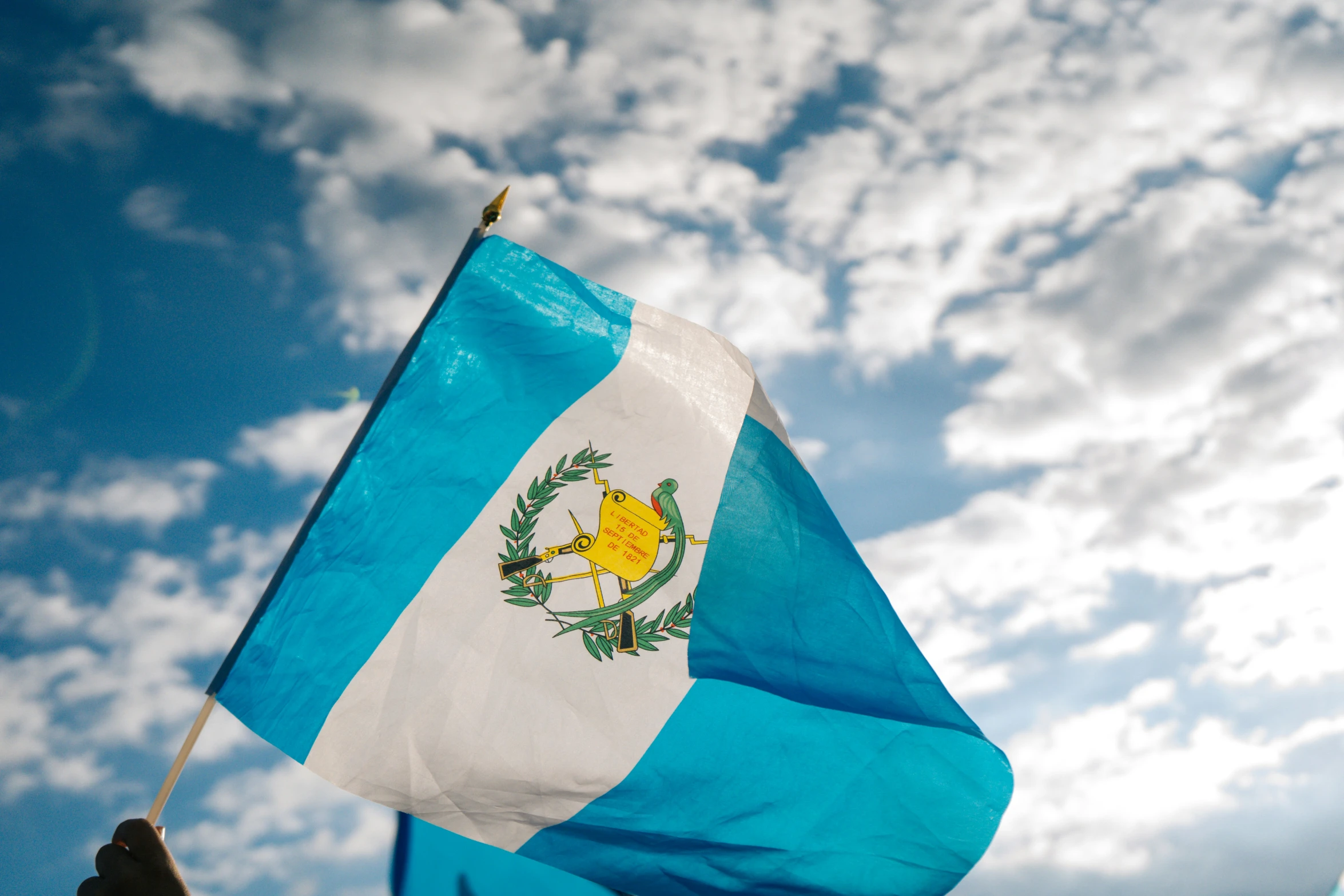 the flag of argentina with blue sky in the background