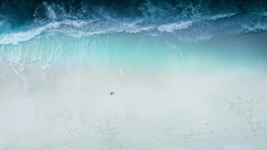 there is a small boat on the beach with foam