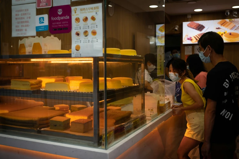 people standing in line waiting in a food court