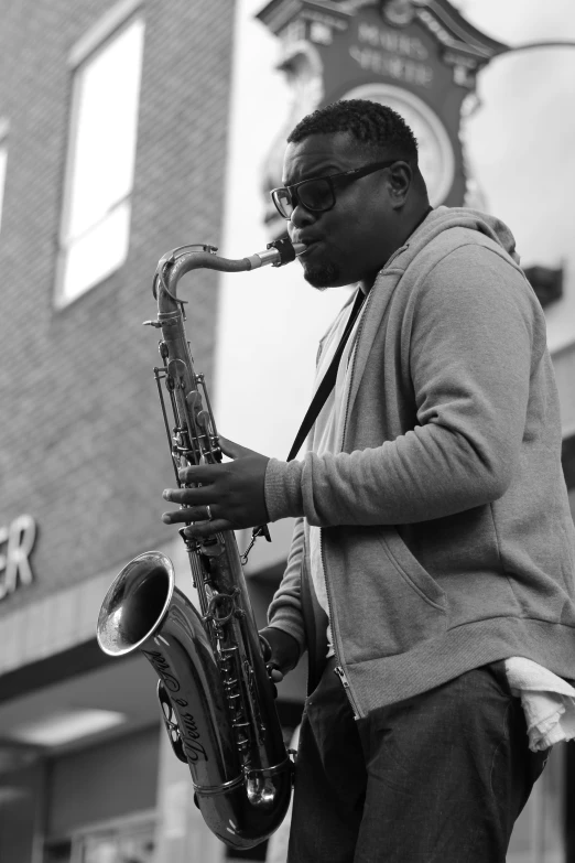 black and white image of a man playing saxophone