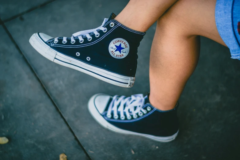 an image of someone wearing converse shoes