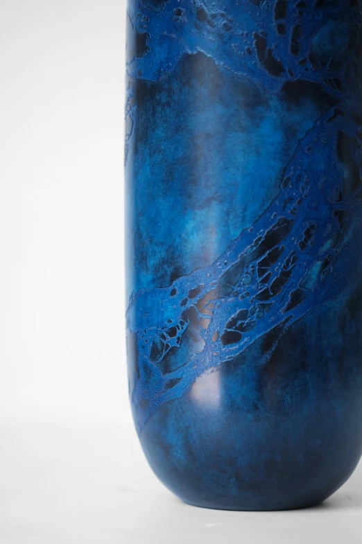 a large blue vase with an abstract design