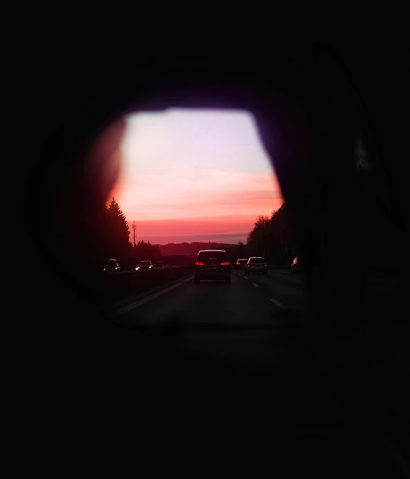 a view from inside a car window into the sunset