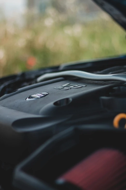 a car with an engine and hood with the top open