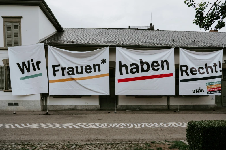 several white banner covering an area near a large building