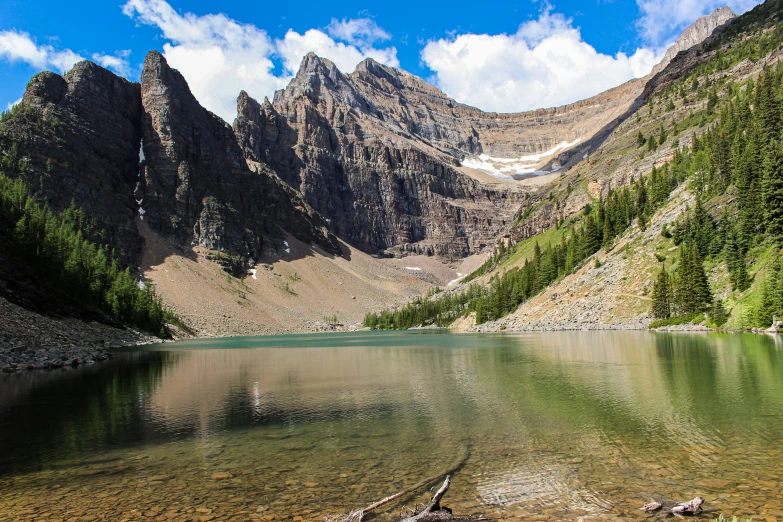 there is a reflection in the water of the mountains