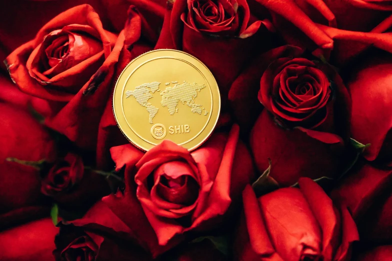 a gold plated medallion in the center of red roses