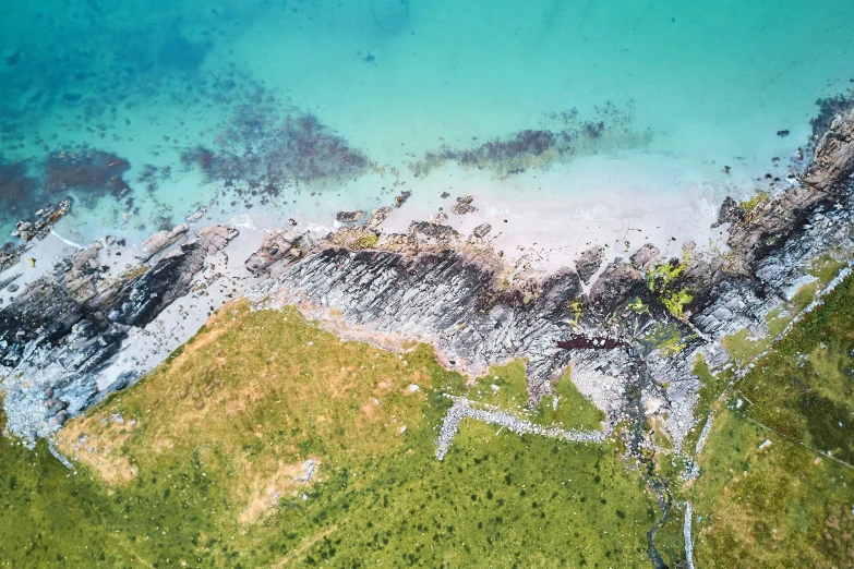 an aerial view of an area of water with mountains in the background