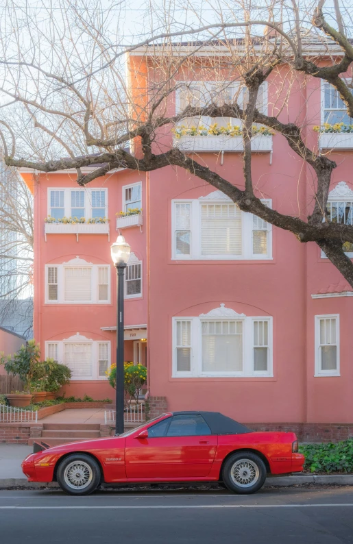 a red sports car parked on the side of the street