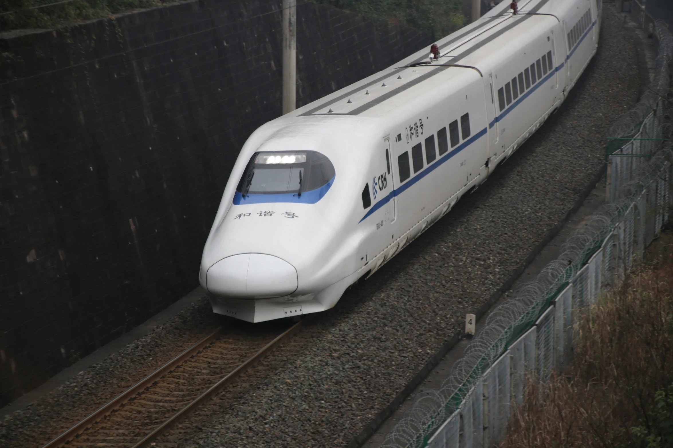 the high speed train travels along on the railroad