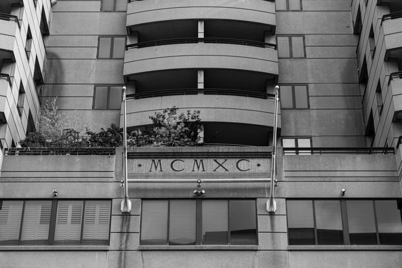 the balcony on a building has flowers hanging over it