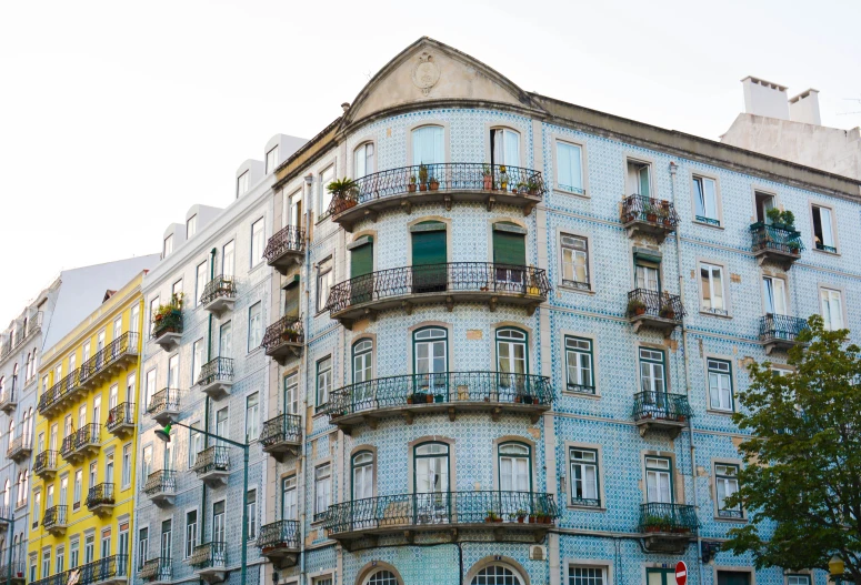 a tall building with balconies and balconies painted blue